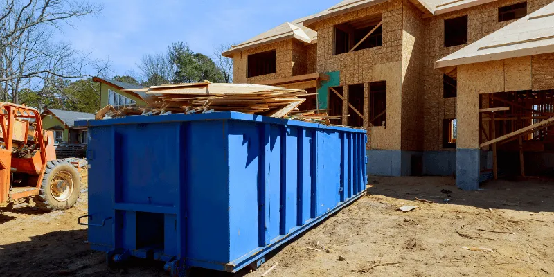 dumpster full of wood at job site