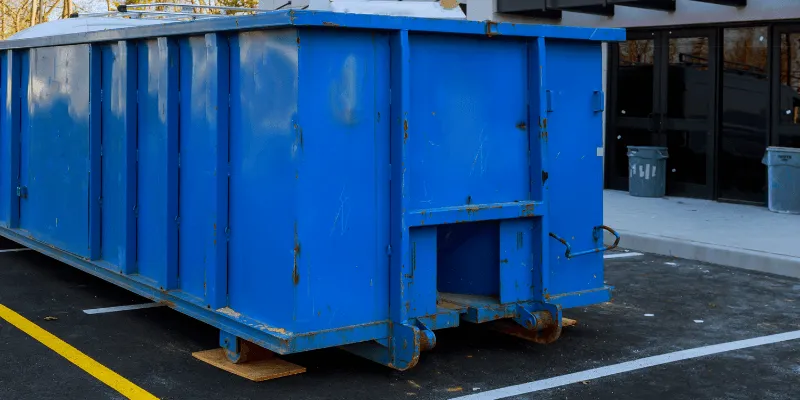 safely placed dumpster on wood to not damage parking lot